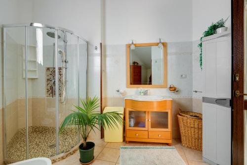 a bathroom with a sink and a glass shower at Casa Rosa in Fluminimaggiore