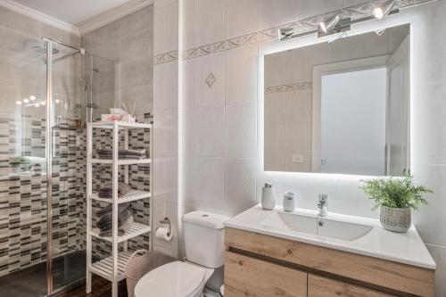 a bathroom with a sink and a toilet and a mirror at Casa Barriguita 2 in Playa Blanca