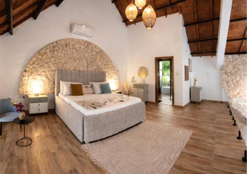 a bedroom with a large bed and a wooden ceiling at Bahari Mirror Villas in Jambiani