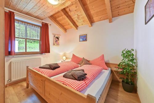 a bedroom with two beds with red and white pillows at Birkenhof - Wohnung Ortler in Sluderno