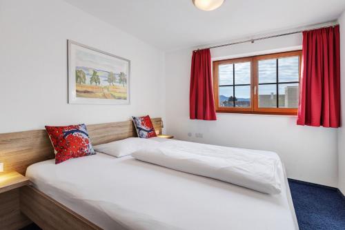 a bedroom with two beds and a window at Untersee Appartements in Moos