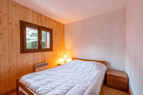 a bedroom with a bed in a room with a window at Appartement Résidence Ours Blanc in Les Houches