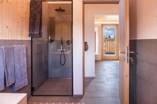 a bathroom with a shower with a glass door at Landhaus Silene in Sarnonico