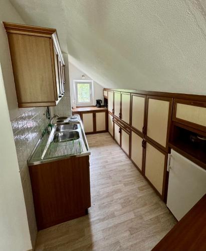 an empty kitchen with a sink and a stove at Ferienwohnung Fuldawiesen in Schlitz