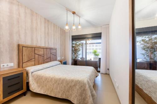 a bedroom with two beds and a mirror at Sofie apartamento turístico in Roquetas de Mar