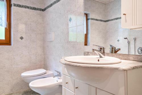 a bathroom with a sink and a toilet at Eggerhof im Sarntal in Sarntal