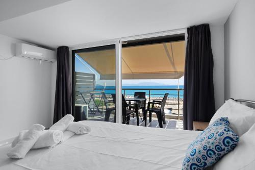 a bedroom with a bed and a view of the ocean at Iguana studio 17 in Preveza