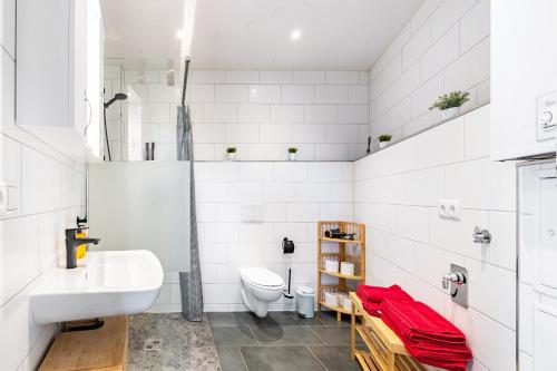 ein weißes Badezimmer mit Waschbecken und Toilette in der Unterkunft Fewo Al Backstuff in Hambuch