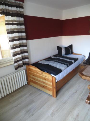 a bedroom with a bed with a wooden frame at Waldblick in Gellersen