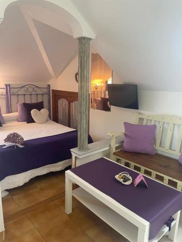 a bedroom with two beds and a table and a tv at Hosteria Las Fuentes in Rubayo