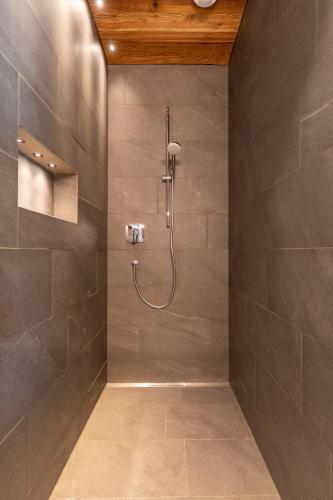 a shower with a shower head in a bathroom at Innerbachlerhof - Gantkofel in Postal