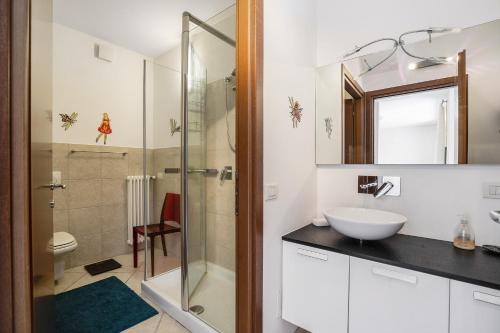 a bathroom with a sink and a glass shower at Casa Marina in Mergozzo