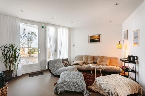 a living room with a couch and a table at Le Phare, Rivedoux Beach House in Rivedoux-Plage