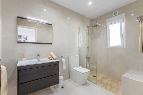a bathroom with a sink and a toilet and a shower at Modern villa with great location in Ciudad Quesada