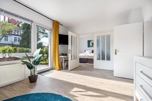 a living room with a large window and a bedroom at Ferienwohnung Deister Blick in Rodenberg