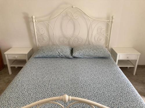 a bedroom with a white bed with two night stands at Fattorialmare Rossa in Camogli