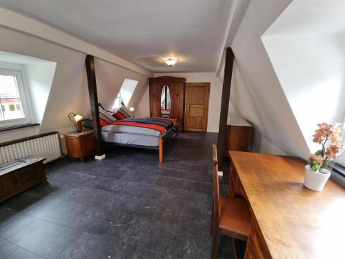 a bedroom with a bed and a wooden table at Traum-Fewo Mosel-Panoramablick in Traben-Trarbach