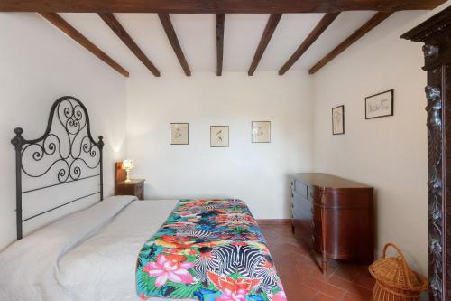 a bedroom with a large bed and a wooden dresser at Universal Harmony - Cardellino in Dicomano