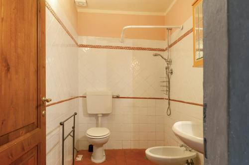 a small bathroom with a toilet and a sink at Universal Harmony - Cardellino in Dicomano