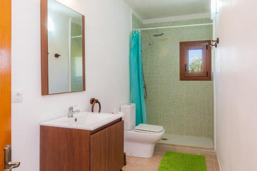 a bathroom with a sink and a toilet and a shower at Sa Casona in Portocolom
