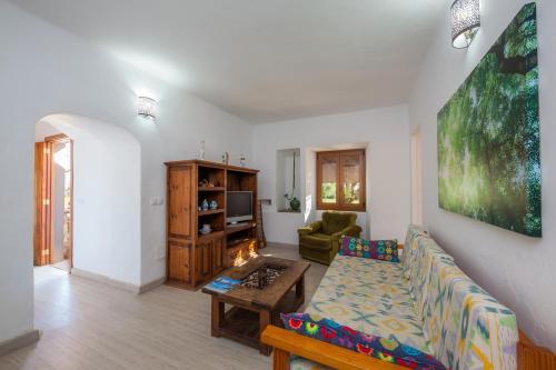 a living room with a couch and a table at Sa Casona in Portocolom