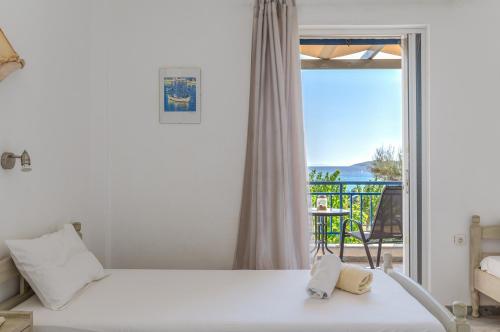a bedroom with a bed and a view of the ocean at Perasma Studio 3 in Kipri