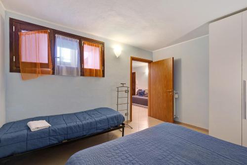 a bedroom with two beds and a door to a room at Casa chicken - mare, monti e bikers in Finale Ligure