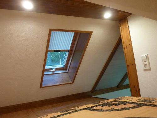 a bedroom with a window and a bed in it at Bienenhaus in Dornhan