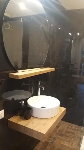 a bathroom with a white sink and a mirror at Appartamento Luxury - Torre in Terracina