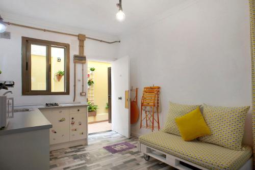 a living room with a yellow pillow on a couch at Las Sales Estudio in Moya