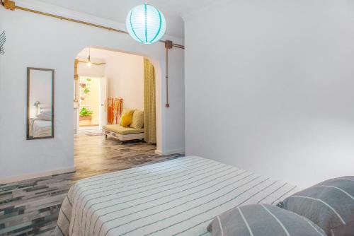 a bedroom with a bed and a living room at Las Sales Estudio in Moya