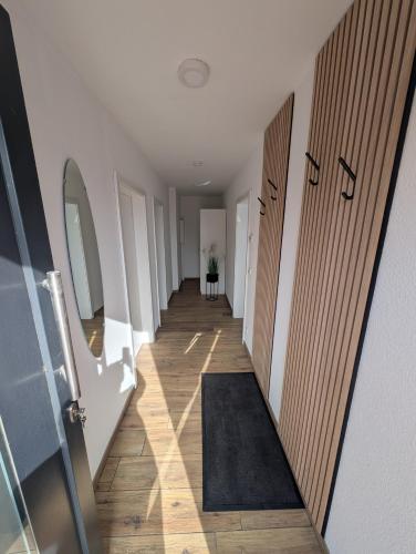 a hallway with doors and a rug on the floor at Ferienwohnung Strandliebe in Lubmin