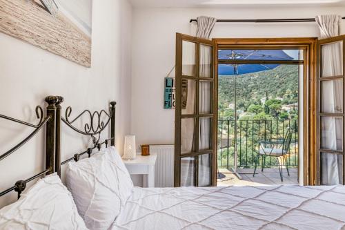 a bedroom with a bed and a door to a balcony at Castell Mirto - villa private pool in Calonge