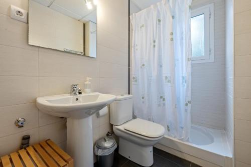 a bathroom with a sink and a toilet and a shower at Dorada Apartment Lluna in Calafell