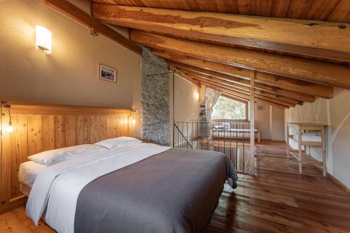 a bedroom with a large bed in a room with wooden walls at Civico 9 in Marmora