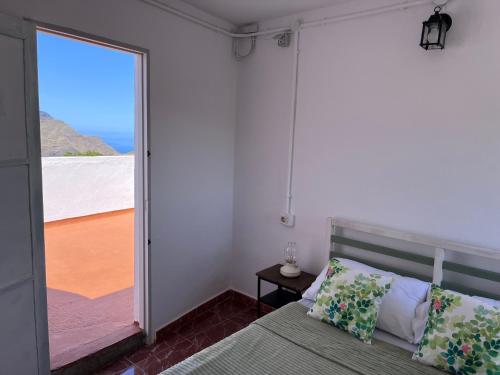 a bedroom with a bed and a view of the ocean at Villa Almagre in Gáldar