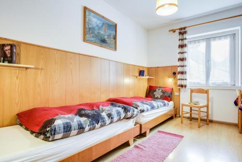 a bedroom with two beds in a room at Ciasa Christina in Moena