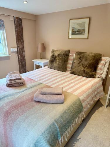 a bedroom with a bed with two towels on it at The Grannery in Wadhurst