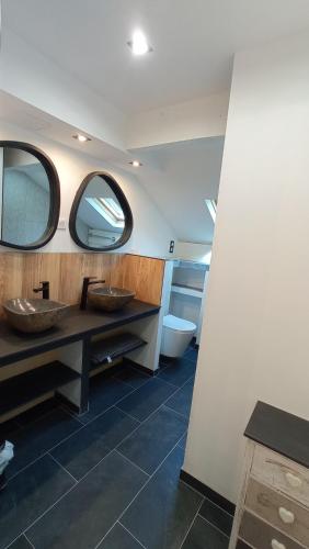 a bathroom with two sinks and a toilet at Sublime Chalet 14 Pers Spa Extrieur in Cauterets