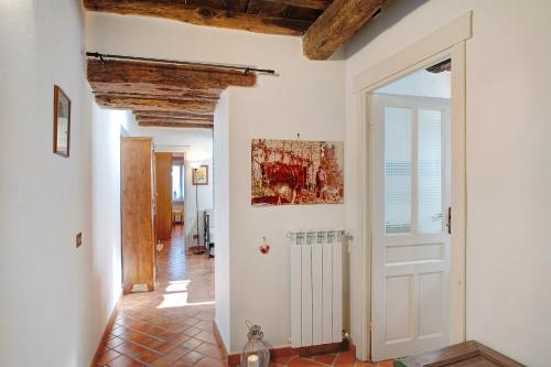 a hallway with a white door and a tile floor at Il piccolo fienile in Vessalico