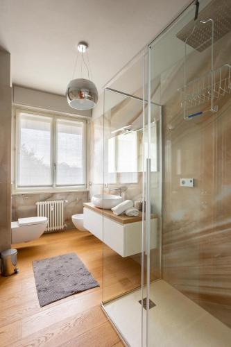 a bathroom with a glass shower and a sink at Suite 51 - Arona in Arona