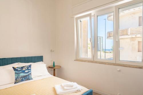 a bedroom with a bed and a window at Micenei Homes in Otranto