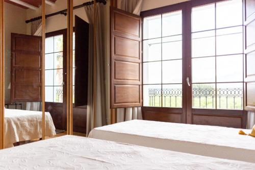 a bedroom with two beds and a large window at Villa Monsalva in Monte San Miguel