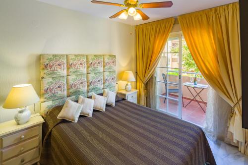 a bedroom with a bed and a ceiling fan at La Reserva de Alvarito in Marbella