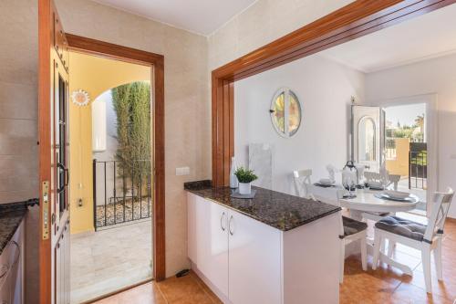 a kitchen and dining room with a table and a dining room at Villa Sueño in Mazarrón
