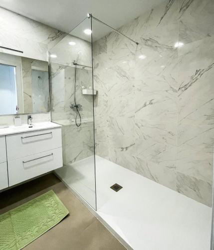 a bathroom with a shower with a glass door at Flat Sun Garden in Torrox