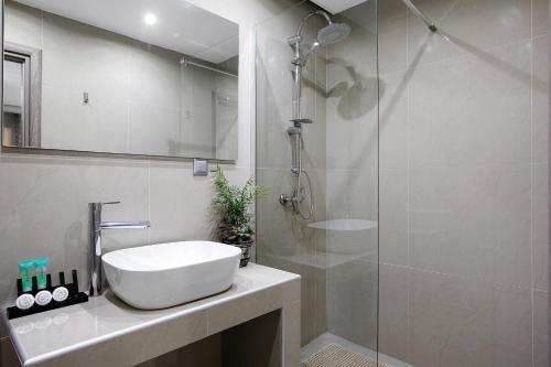 a bathroom with a sink and a glass shower at Villa Dionysia Studio S6 in Alikanas