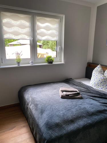 a bedroom with a bed and a window with shutters at Zum Kölpiensee in Peenemünde