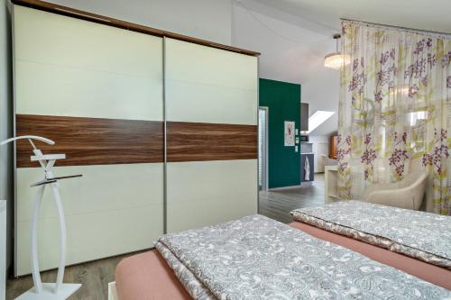 a bedroom with a bed and a glass wall at Loft Schwenck in Kressbronn am Bodensee