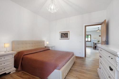 a bedroom with a large bed and a hallway at Casa Loppia 2022 in Caprino Veronese